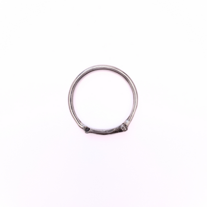A silver ring is photographed from above on plain white background. Part of the band of the ring is the solid silver casting of a little bone. The details are oxidised to show all the beautiful natural texture.
The angle of the photo demonstrates the smooth inside-profile of the ring to reassure the viewer that it's comfortable to wear and won't dig in.