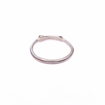 A silver ring is photographed from behind on plain white background. Part of the band of the ring is the solid silver casting of a little bone. 
The angle of the photo demonstrates the smooth inside-profile of the ring to reassure the viewer that it's comfortable to wear and won't dig in.