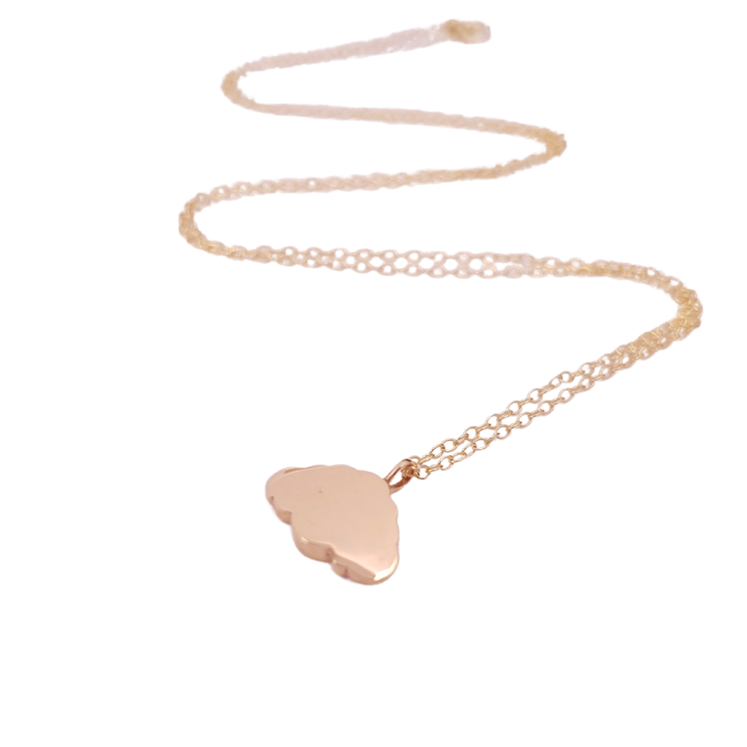 A 9ct gold chain necklace with a minimalist cloud-shaped pendant hung on a dainty 9ct gold chain. Laid on a white background