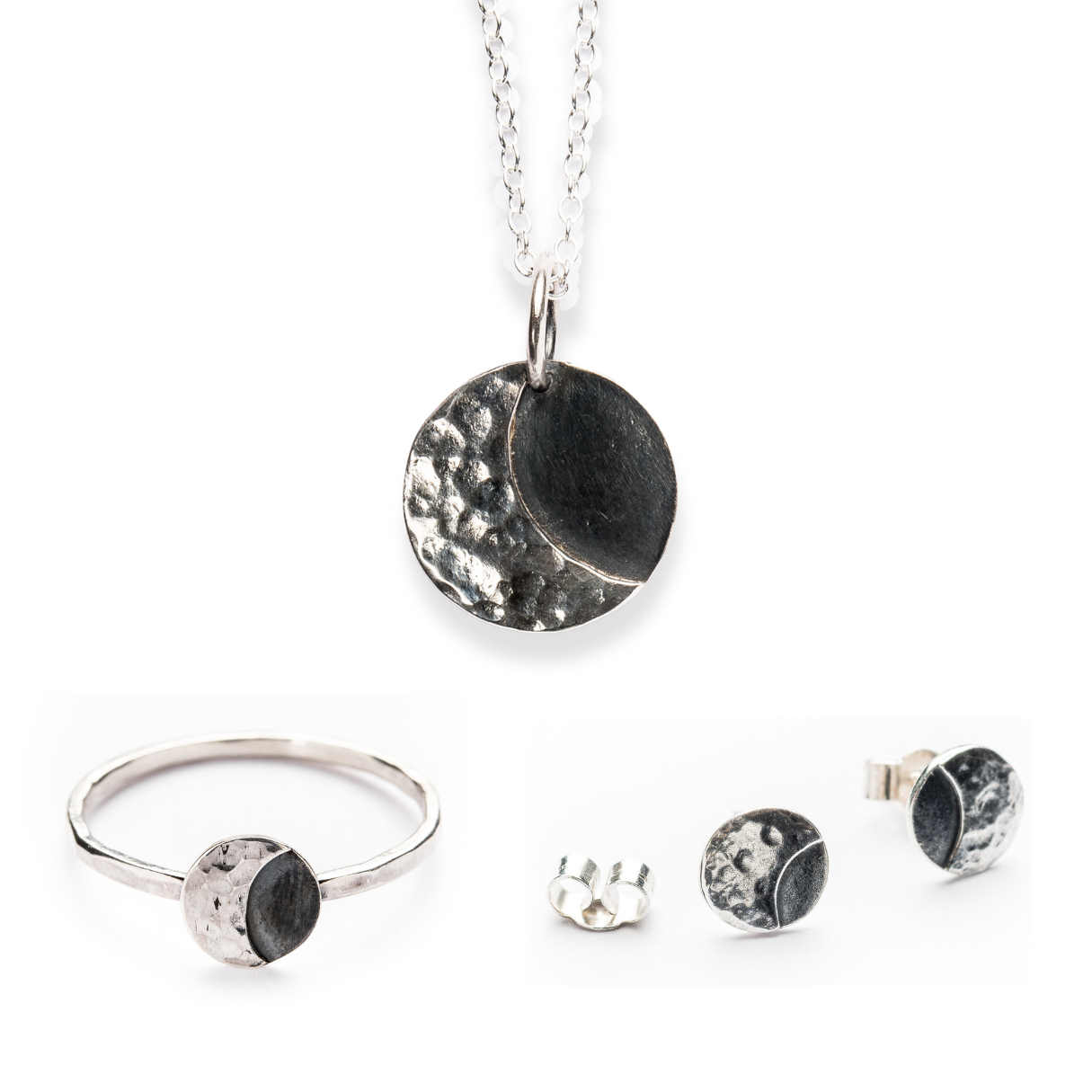 A set of lunar sterling silver jewellery including 2 rings, a pair of stud earrings, and a necklace, featuring a textured and smooth finish with a moon motif.