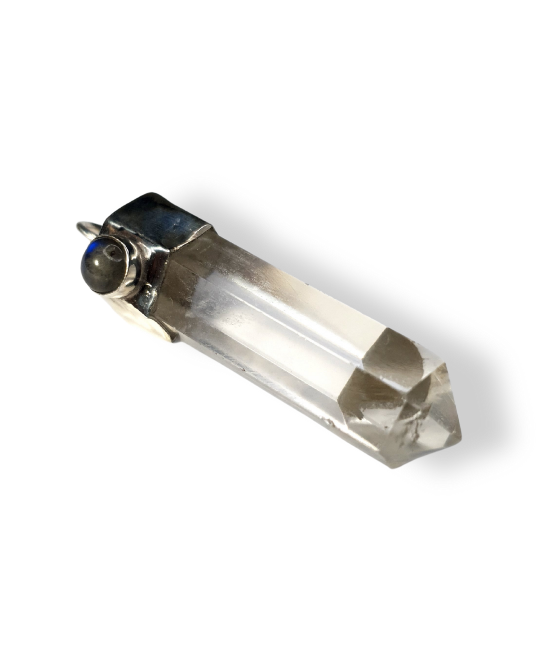 A clear quartz crystal point pendant with a sterling silver setting, adorned with a small labradorite stone, displayed against a white background. You can see a bright blue flash through the labradorite. The quartz tower point is beautifully angular.