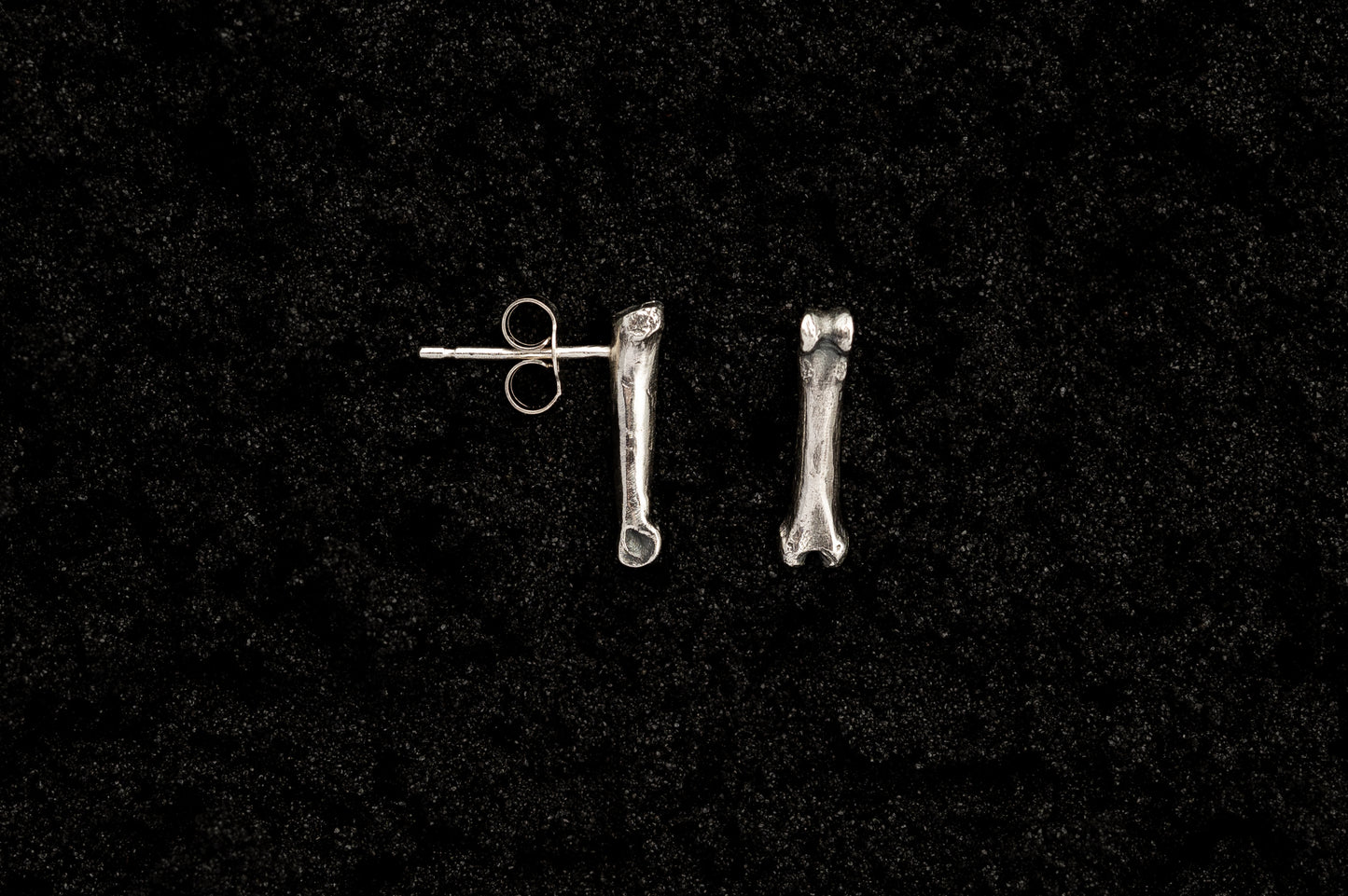 Silver Bone Studs on Black Sand