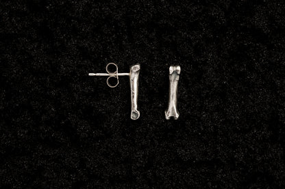 Silver Bone Studs on Black Sand