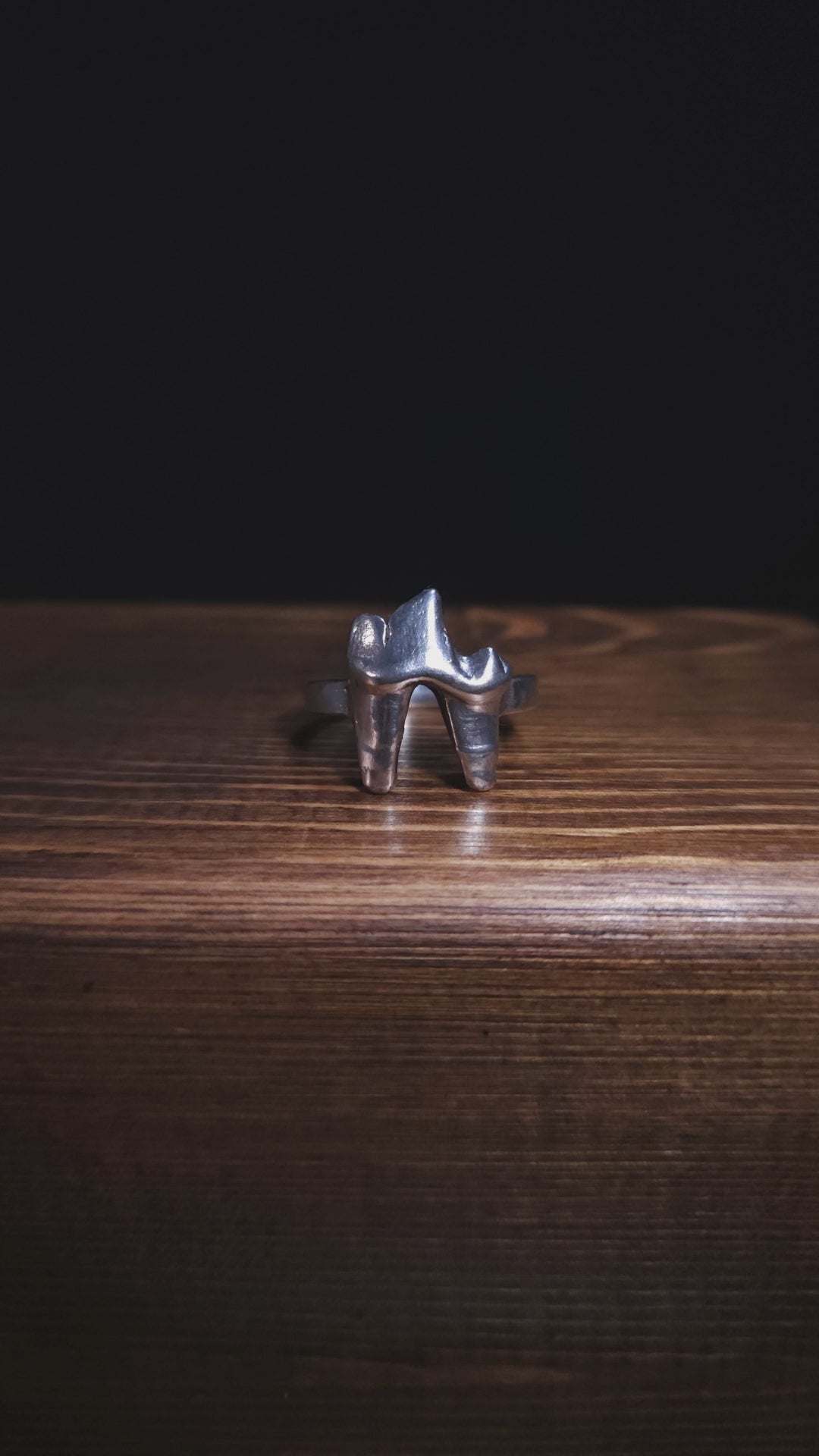 A stop motion video shows a sterling silver fox tooth ring rotating clockwise so you can see it from all angles.